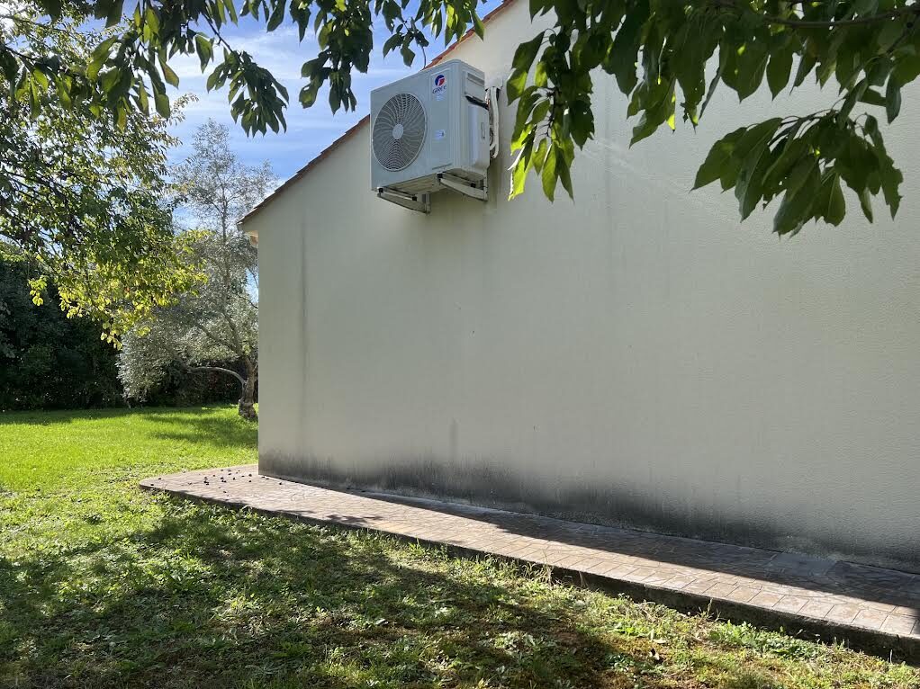 Unité extérieure discrètement intégrée près du jardin